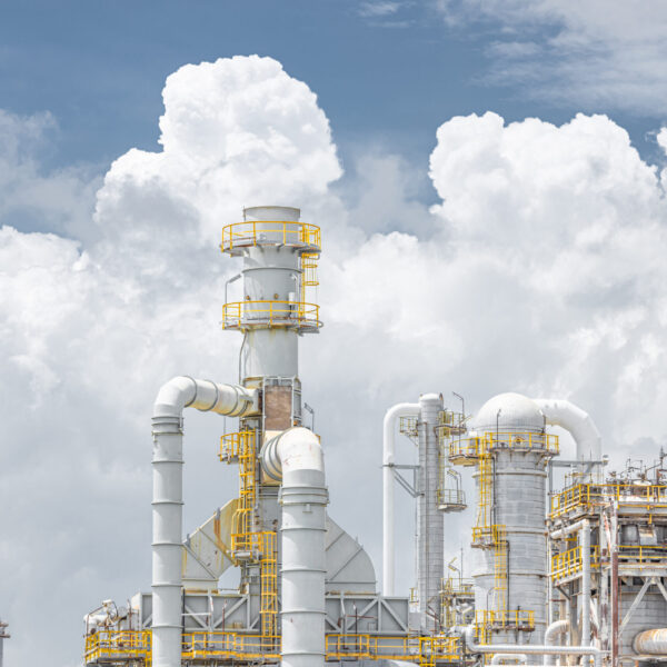 Oil petroleum refinery plant building distillation columns tower, Closeup part of fuel gas pipe complex, Crude oil petrochemical industrial building.